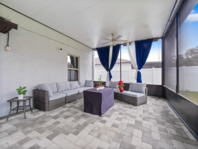 sunroom featuring ceiling fan