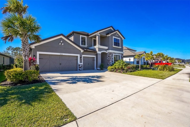 view of front of home featuring a garage and a front lawn