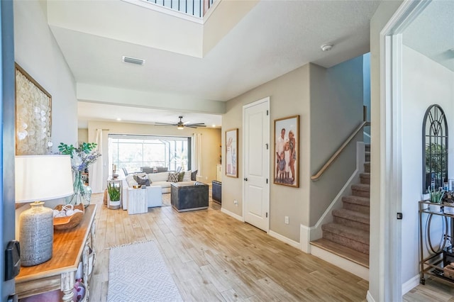 foyer with ceiling fan and light hardwood / wood-style flooring