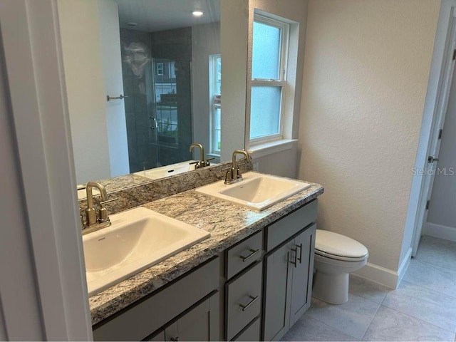 bathroom with vanity, toilet, tile patterned flooring, and an enclosed shower