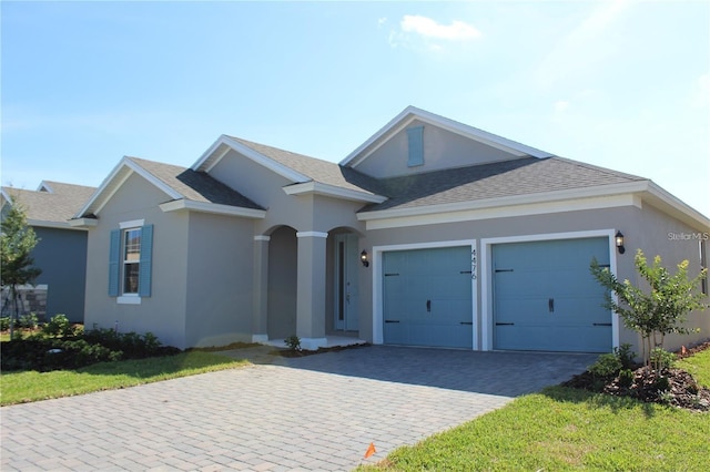 view of front of property with a garage and a front yard