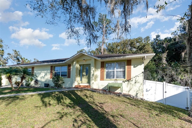 ranch-style home featuring a front yard