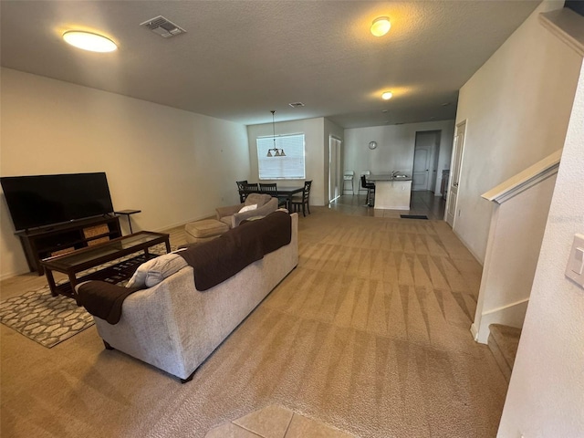 living room with light carpet and a textured ceiling