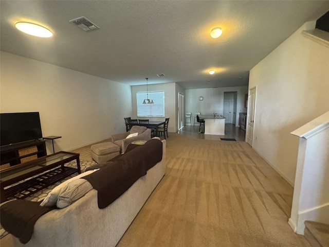 carpeted living room featuring a textured ceiling