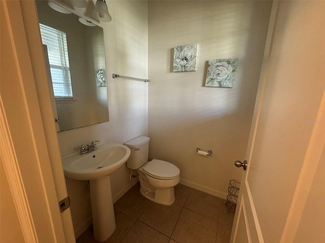 bathroom with sink, tile patterned floors, and toilet