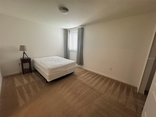 bedroom featuring carpet floors and a textured ceiling