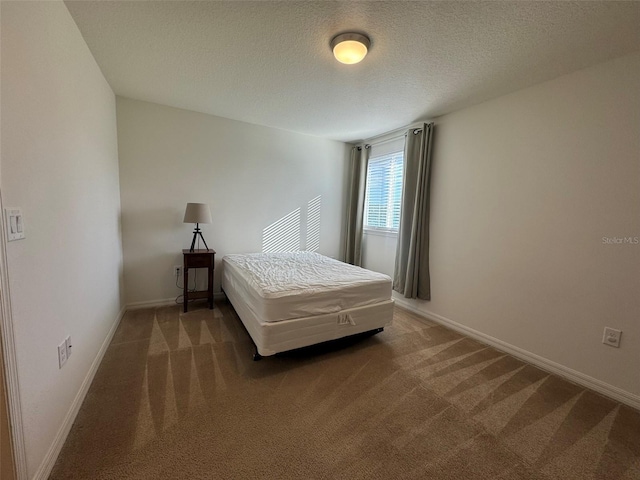 carpeted bedroom featuring a textured ceiling