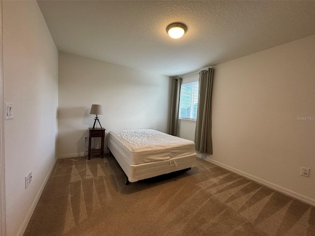 unfurnished bedroom with dark carpet and a textured ceiling