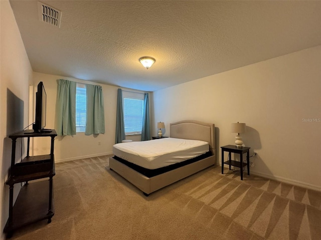 carpeted bedroom with a textured ceiling