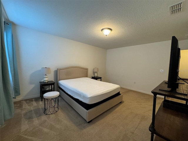 bedroom featuring carpet flooring and a textured ceiling