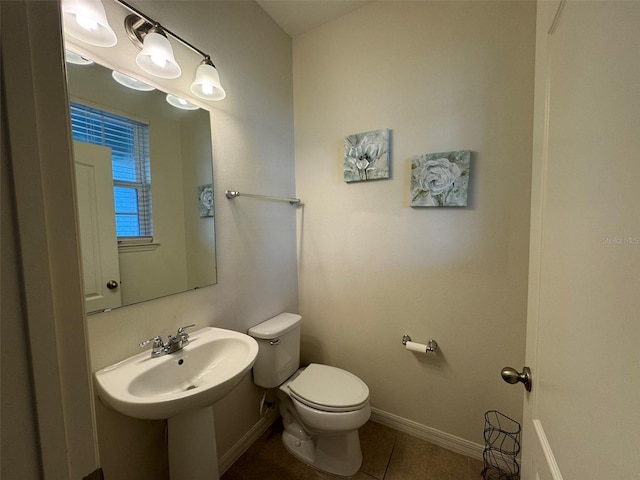 bathroom featuring tile patterned floors, toilet, and sink