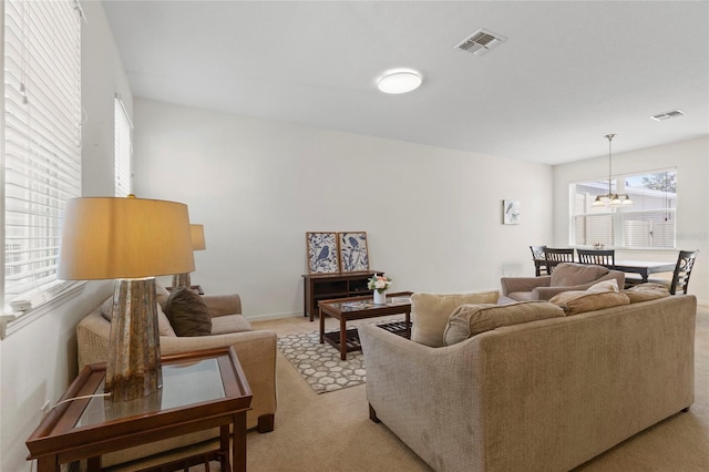 13731 Bravante Aly, Windermere, FL 34786 - living room with light carpet, a chandelier, and baseboards
