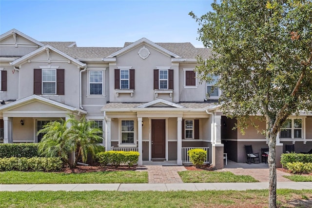 13731 Bravante Aly, Windermere, FL 34786 - townhome / multi-family property featuring a porch, stucco siding, and a shingled roof
