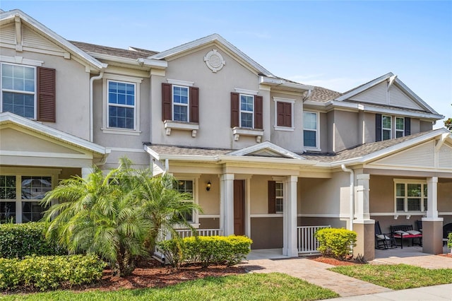 13731 Bravante Aly, Windermere, FL 34786 - townhome / multi-family property featuring covered porch, stucco siding, and roof with shingles