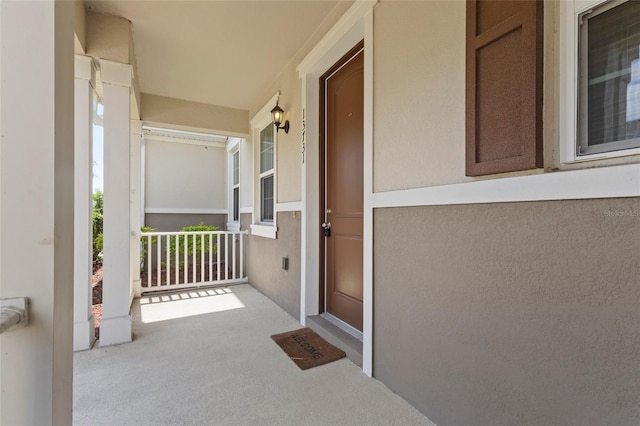 13731 Bravante Aly, Windermere, FL 34786 - doorway to property with covered porch and stucco siding