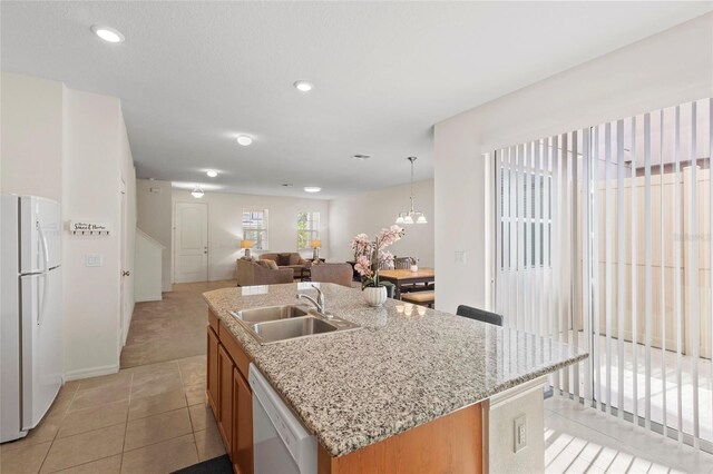 13731 Bravante Aly, Windermere, FL 34786 - kitchen with white appliances, a sink, open floor plan, light tile patterned floors, and a kitchen island with sink