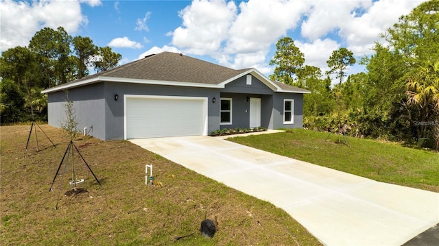 view of front of home featuring a front yard and a garage