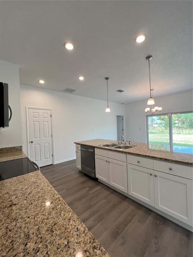 kitchen featuring white cabinetry, hanging light fixtures, stainless steel dishwasher, light stone counters, and sink