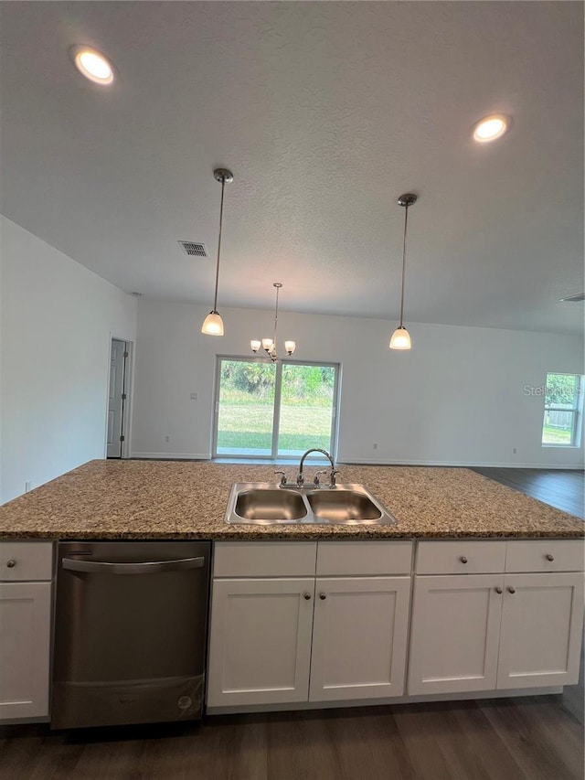 kitchen featuring pendant lighting, stainless steel dishwasher, white cabinets, light stone counters, and sink