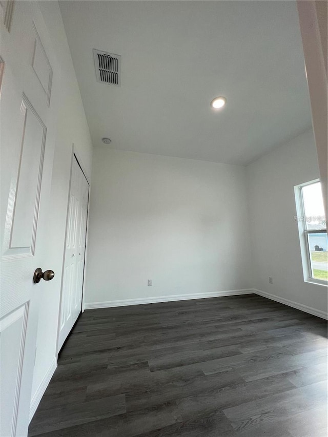 unfurnished bedroom with dark wood-type flooring