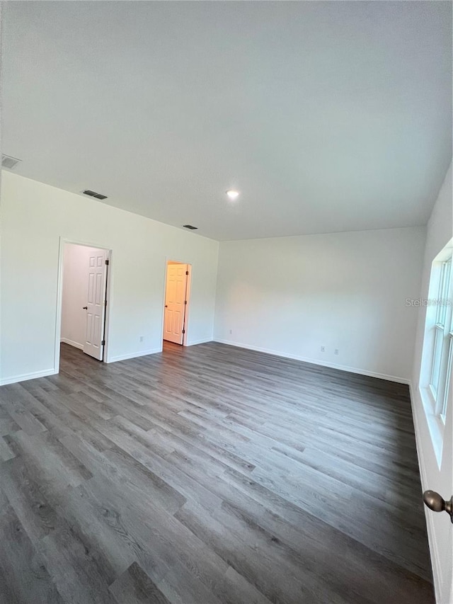 unfurnished room featuring dark wood-type flooring