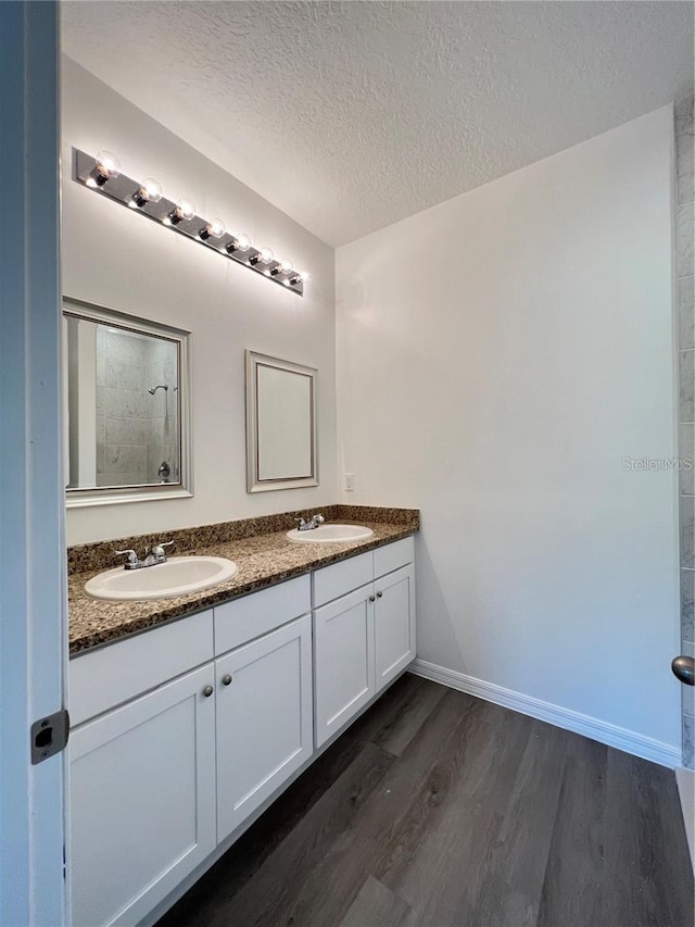 bathroom featuring vanity, a textured ceiling, and hardwood / wood-style floors