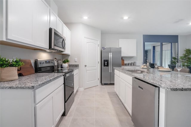 kitchen with a center island with sink, sink, stainless steel appliances, and white cabinetry