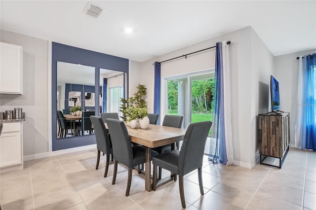 dining space featuring light tile patterned floors