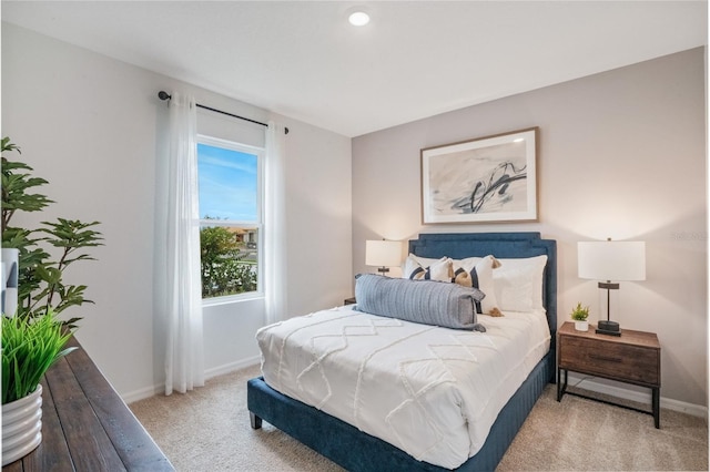 bedroom featuring light colored carpet