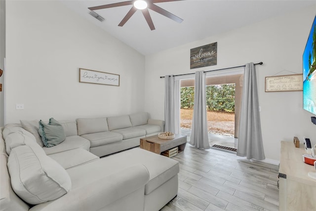 living room with ceiling fan and lofted ceiling