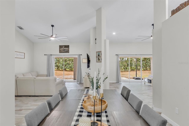 dining space with light wood-type flooring and ceiling fan