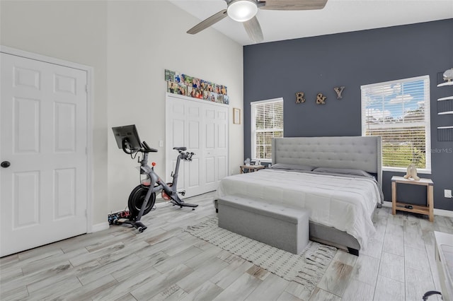 bedroom with ceiling fan, multiple windows, and a closet