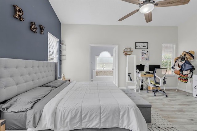 bedroom with ceiling fan, ensuite bath, and wood-type flooring