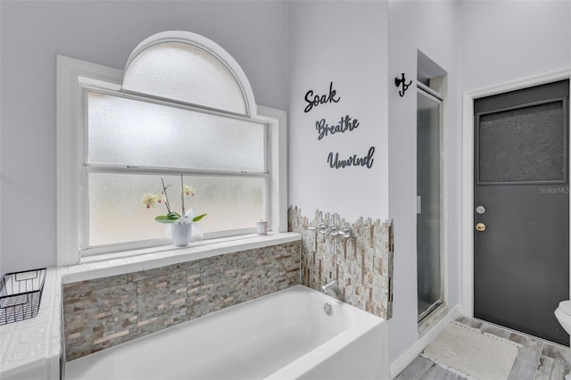 bathroom with shower with separate bathtub