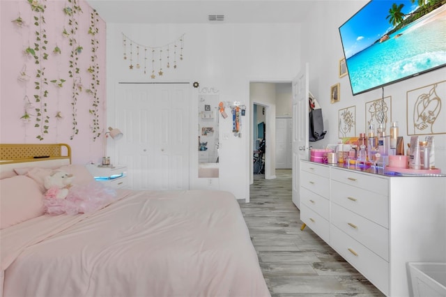 bedroom featuring light wood-type flooring and a closet