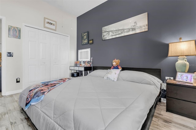 bedroom with light wood-type flooring and a closet