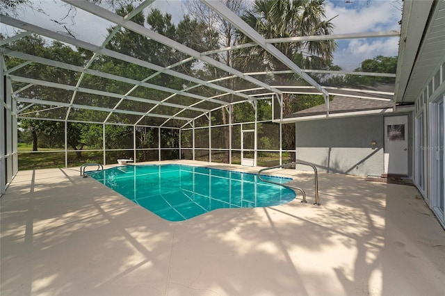 view of swimming pool featuring a patio area and a lanai