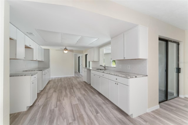 kitchen with white cabinets, backsplash, and sink