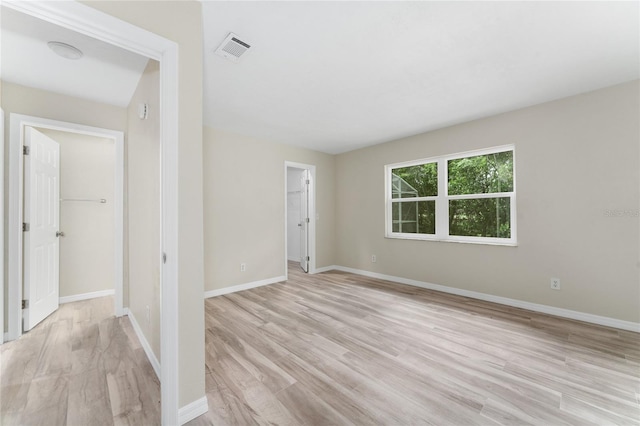 spare room with light hardwood / wood-style floors