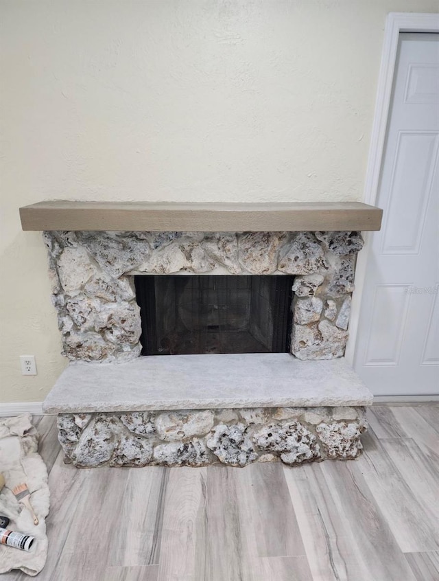 interior details featuring a fireplace and hardwood / wood-style flooring