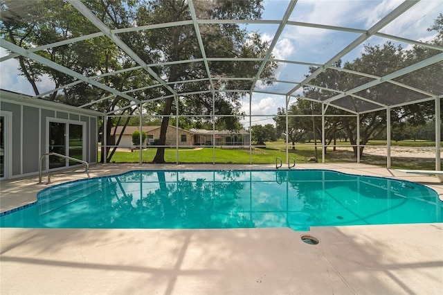 view of pool with a lanai, a patio, and a yard