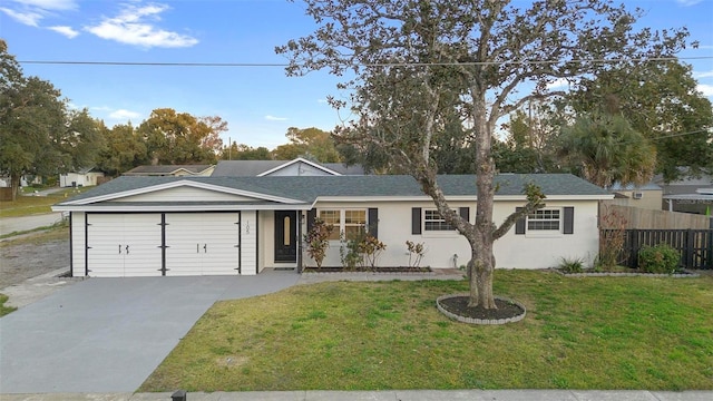 ranch-style home featuring a garage and a front lawn