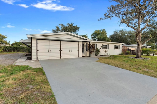 ranch-style house featuring a front lawn and a garage