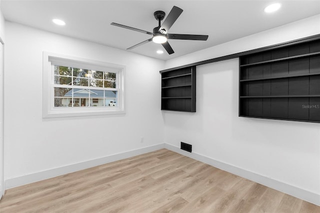 unfurnished room with ceiling fan and light hardwood / wood-style floors