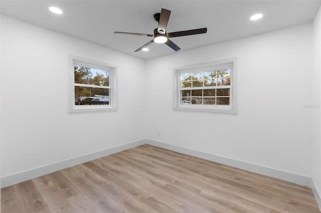 unfurnished room with ceiling fan, a wealth of natural light, and light hardwood / wood-style flooring