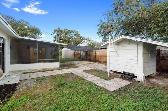 view of yard featuring a patio area and a sunroom