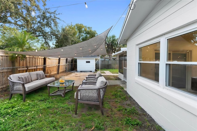 view of patio / terrace featuring a storage shed, an outdoor hangout area, an outbuilding, and a fenced backyard