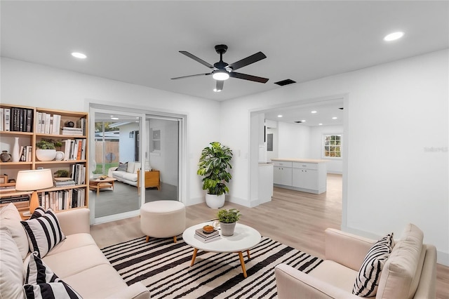 living room with ceiling fan, recessed lighting, visible vents, and light wood-type flooring