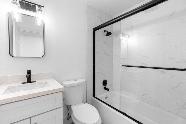 bathroom with toilet, vanity, and combined bath / shower with glass door