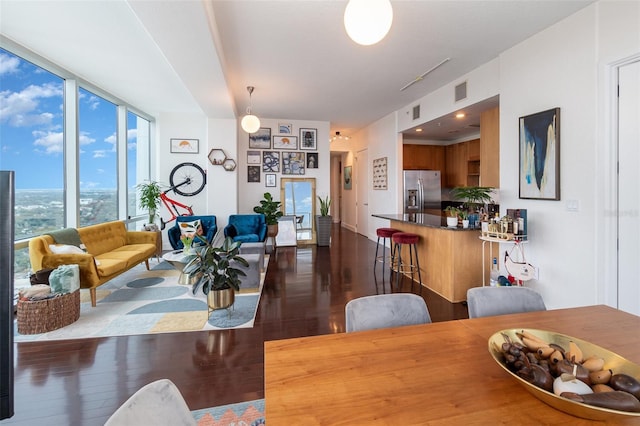 dining area featuring dark hardwood / wood-style floors and expansive windows